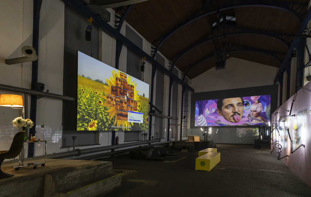 Immersive digital art installation in industrial gallery with sunflower field and surreal portrait projections